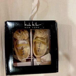Nicole Miller gold baby shoe